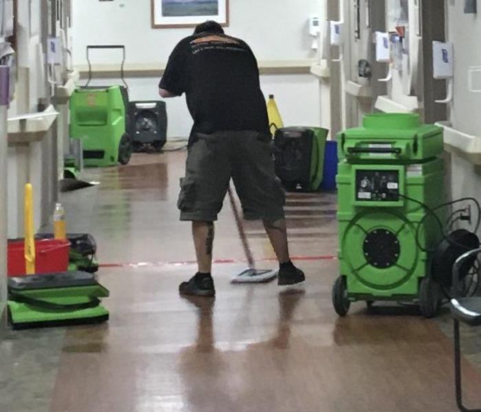 SERVPRO Employee mopping up water