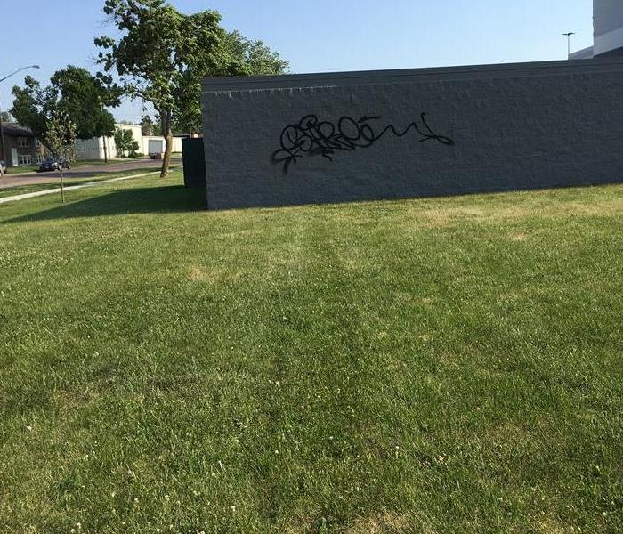 Outdoor wall of commercial facility with graffiti