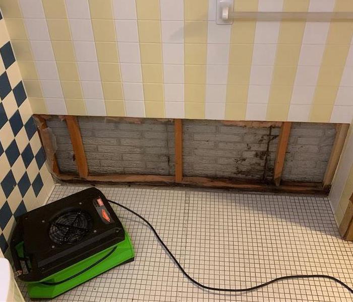 Tile removed from shower wall to allow for optimal drying