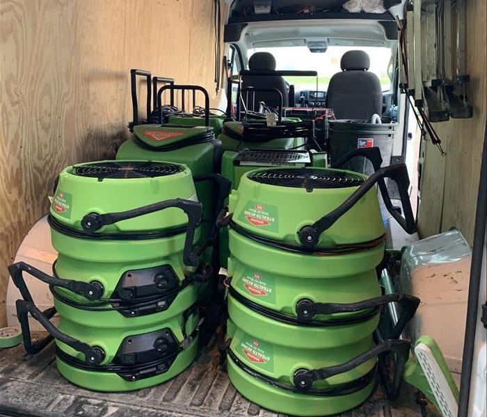 Green SERVPRO fans loaded up in a van ready for a job site