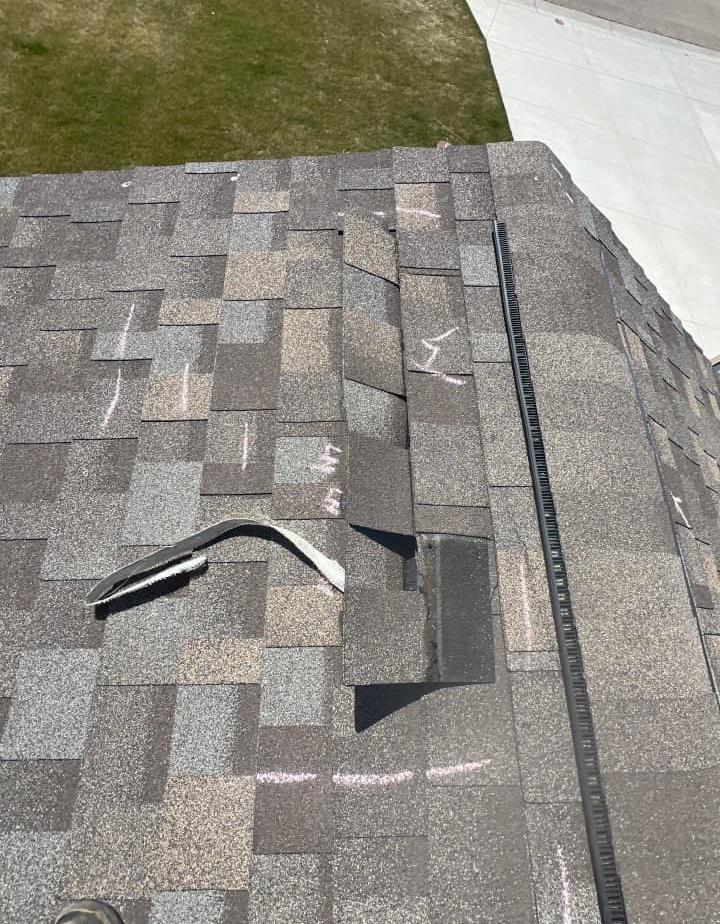 Roof shingles damaged by wind