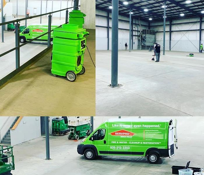 SERVPRO employees and vehicles on a commercial job site.