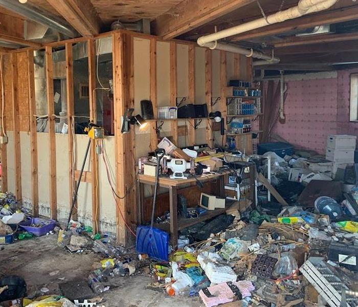 Basement filled with garbage and debris