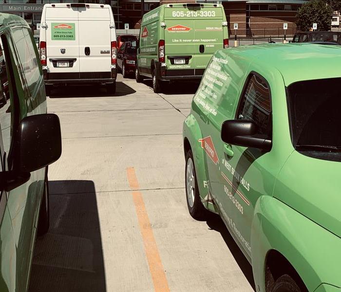 Green SERVPRO vehicles on a job site