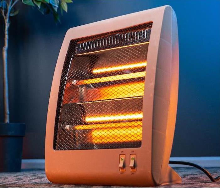 img src =”heater” alt = "a small electric heater in a living room” >
