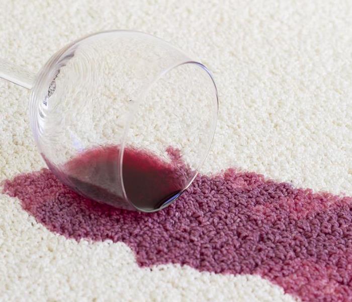Glass of red wine spilled on carpet