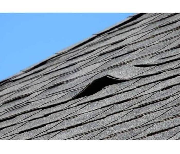 Roof shingles damaged by wind