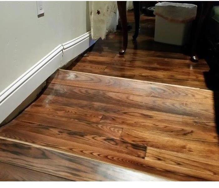 Wood flooring that has buckled from water damage